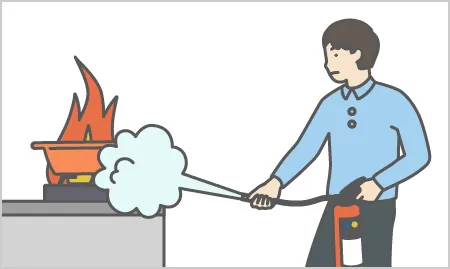 消火器で火を消している人のイラスト。